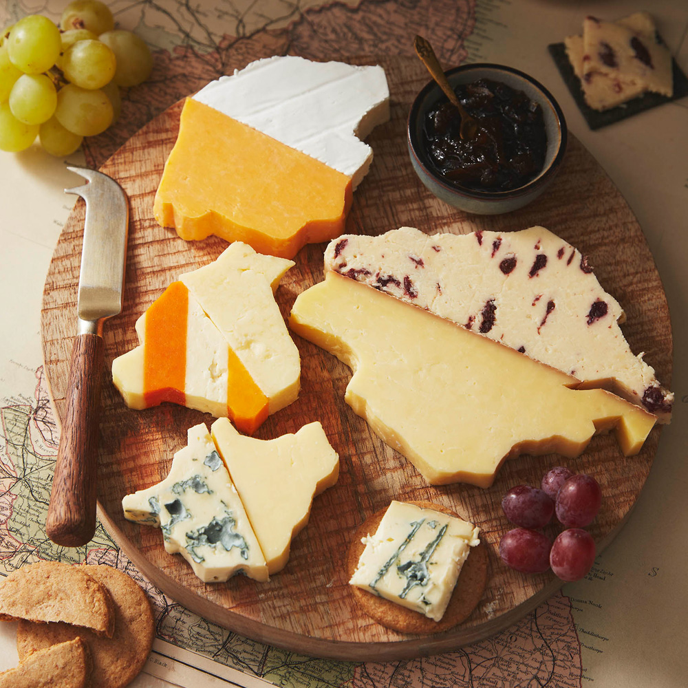Image of a cheeseboard with each cheese in the shape of the counties that make up the North West