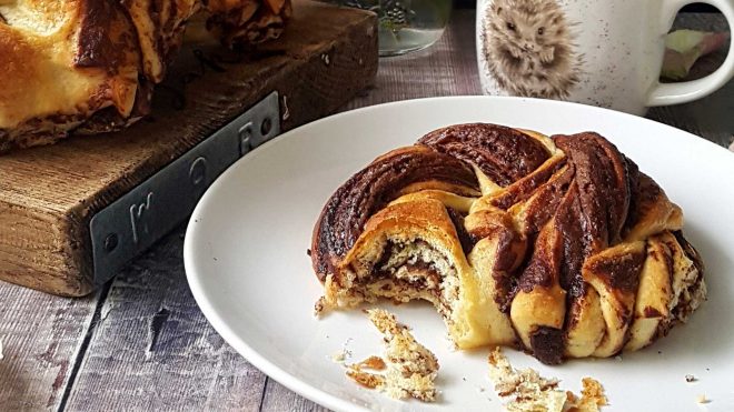 No Knead Chocolate Brioche served on a plate with a portion removed to see the filling