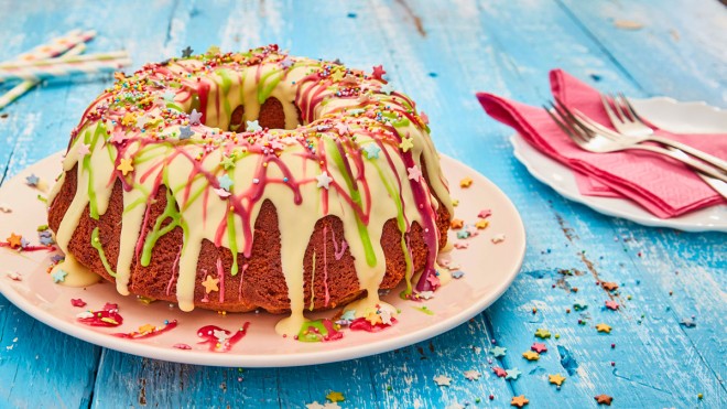 Chocolate Rainbow Cake decorated with white chocolate, coloured chocolate and sprinkles