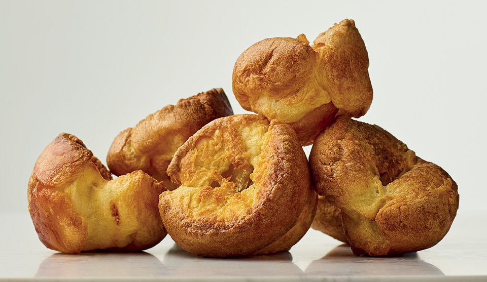 Perfect Yorkshire Puds stacked on top of one another