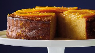 Gluten-Free Zesty Orange Polenta Cake served on a white dish with a slice removed