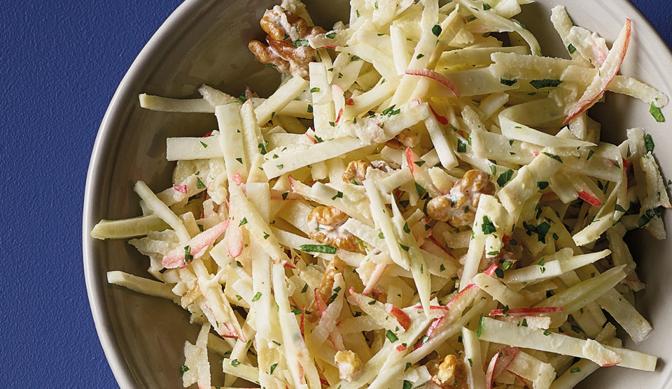 Celeriac, Fennel and Apple Salad with parsley and walnuts served in a grey bowl