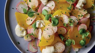 Roasted Golden Beetroot, Watercress and Goats Cheese Salad served on a grey plate and topped with chives