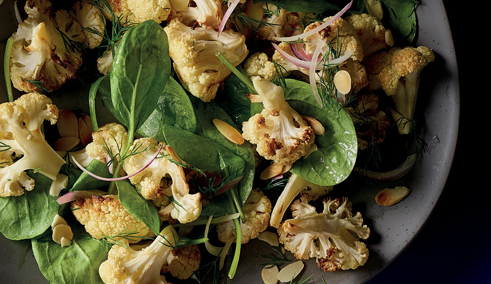 Roasted Cauliflower, Dill and Spinach Salad served on a grey plate