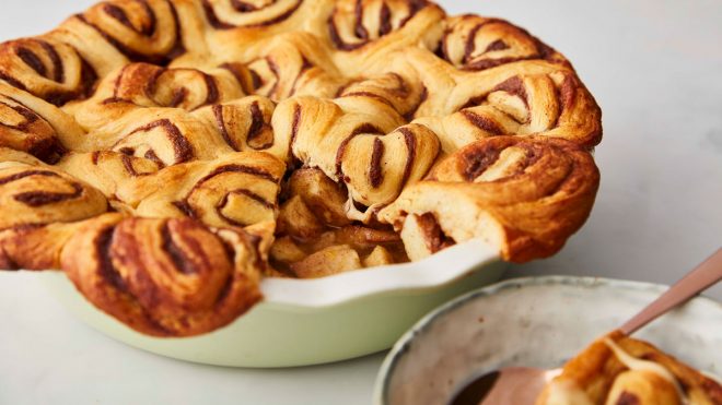 Apple and Cinnamon Swirl Pie served in a baking dish, with a portion removed to see the filling