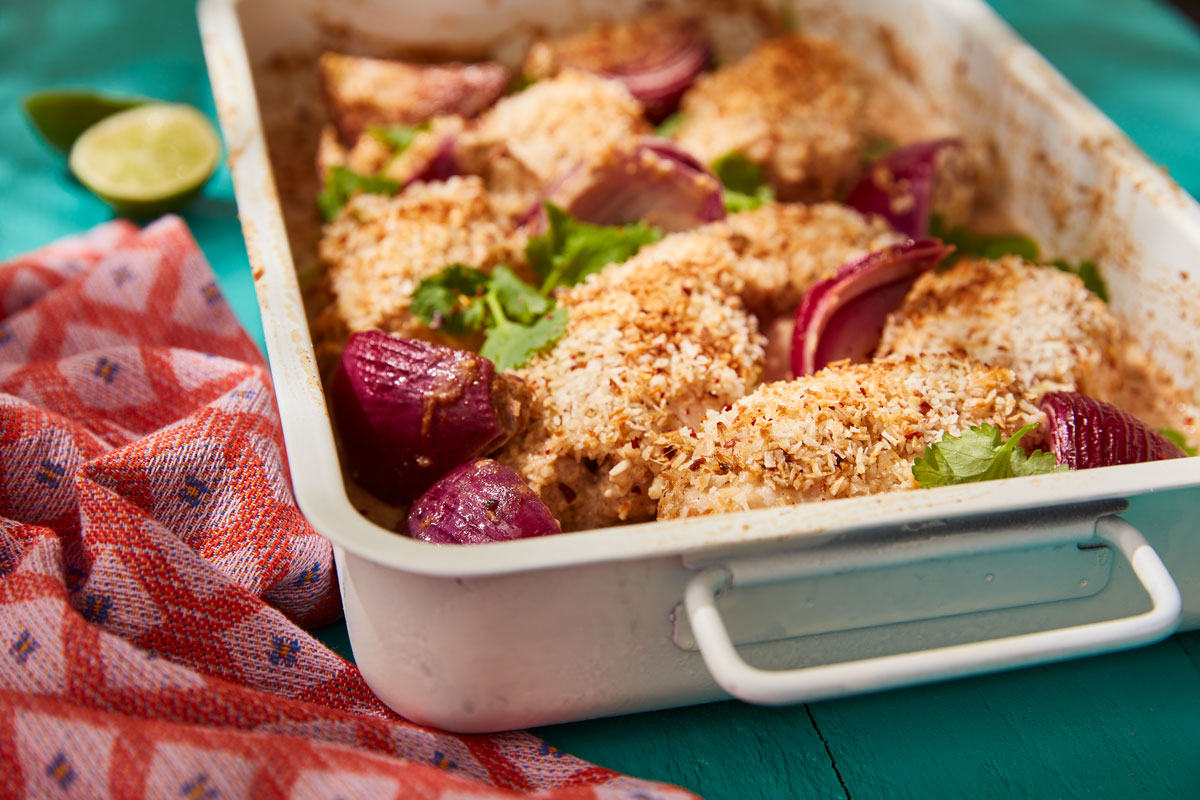 Coconut and Cardamom Chicken Tray Bake served in a baking dish topped with coriander