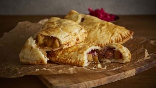 Corned Beef Hashties served on parchment paper, sliced to see the filling