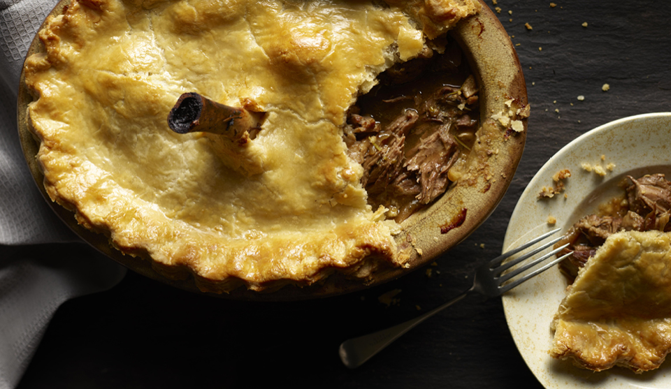 Cumbrian Chimney Pot Pieserved in a dish, with a portion removed to show the filling