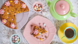 Mini Egg Cookie Pie served on a purple plate with a slice removed and a cup of tea