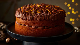 Orange Jaffa Chocolate Drizzle Cake served on a black cake dish