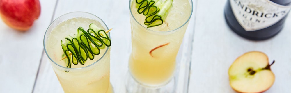 English Garden Gin Cocktail served in glasses with ice, cucumber slices and apple slices