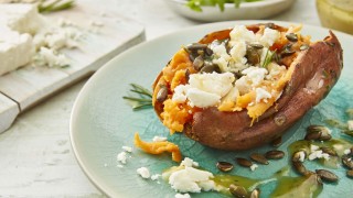 Baked Sweet Potato with Feta, Rosemary and Honey, drizzled with olive oil and sprinkled with toasted pumpkin seeds