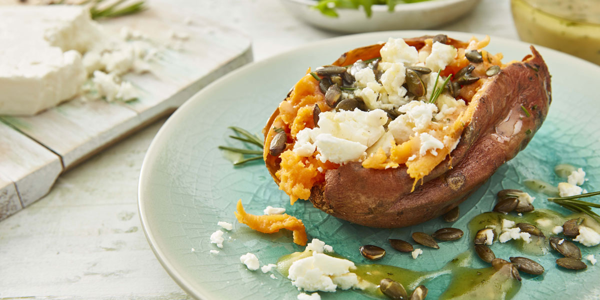 Baked Sweet Potato with Feta, Rosemary and Honey, drizzled with olive oil and sprinkled with toasted pumpkin seeds