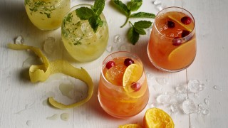 Fresh and Fruity Non Alcoholic Cocktails served in four glasses surrounded by fruit peel and crushed ice