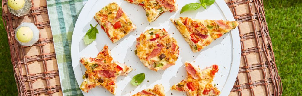 Traybake Frittata Picnic Bites served in various shapes on top of a picnic basket