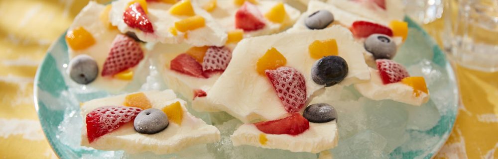 Forozen Yoghurt Barkserved on top of ice cubes on a blue plate