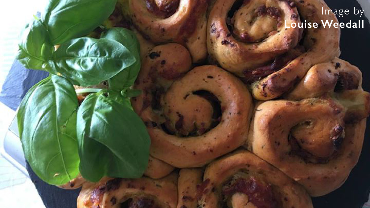 Parma Ham, Pesto and Mozzarella Tear and Share Bread served on a slate with basil