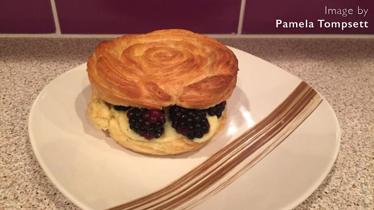 Lemon and Blackberry Paris-Brest served on a plate