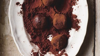 Homemade Truffles in a white dish in cocoa powder