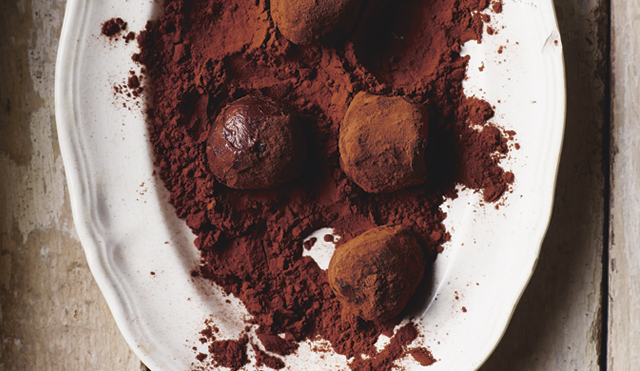 Homemade Truffles in a white dish in cocoa powder