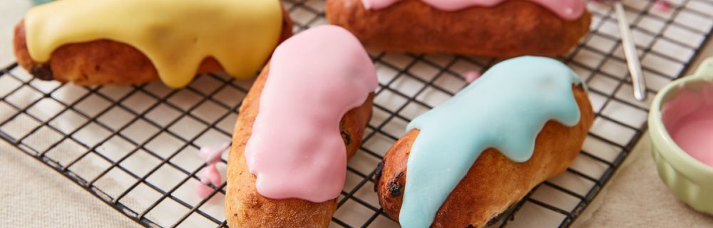 Iced Fingers served on a cooling rack with different coloured icings on top