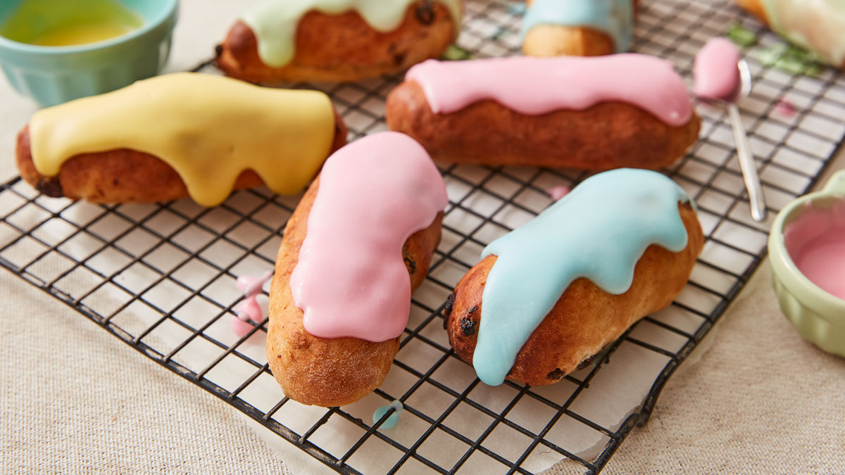 Iced Fingers served on a cooling rack with different coloured icings on top