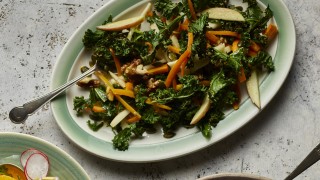 Kale, Apple and Walnut Salad served on a green dish