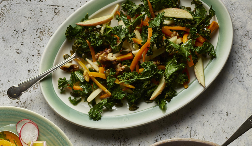 Kale, Apple and Walnut Salad served on a green dish