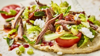 Lamb, Mint and Feta Wraps with Kale Crisps topped with spring onions