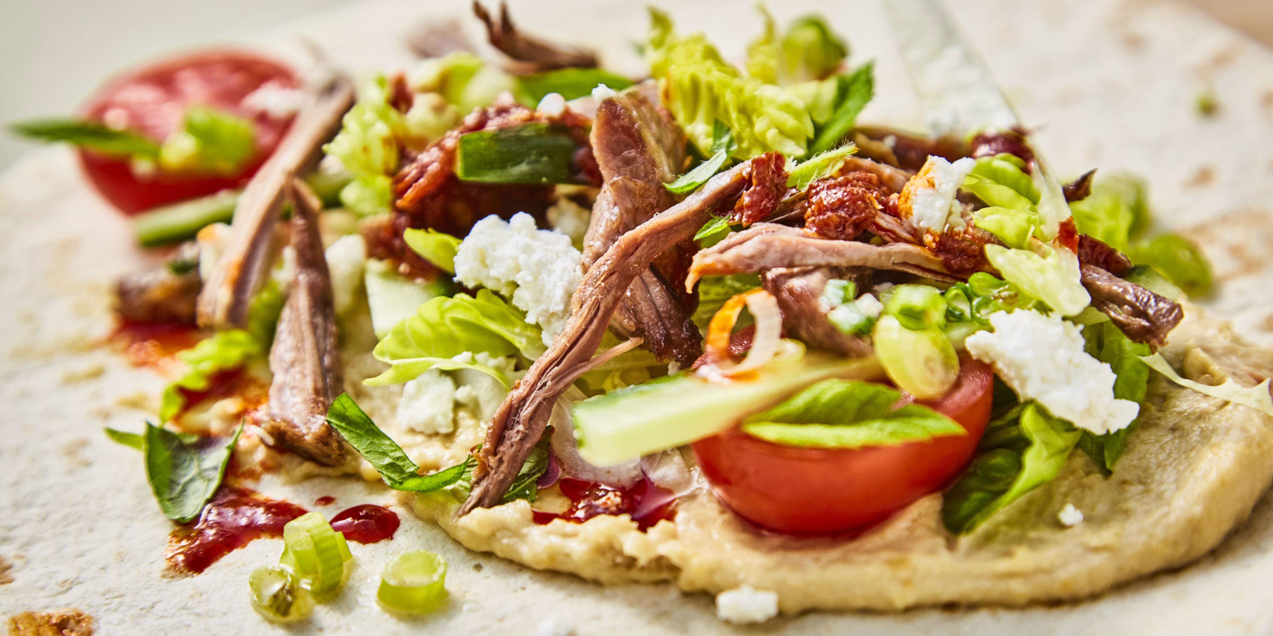 Lamb, Mint and Feta Wraps with Kale Crisps topped with spring onions