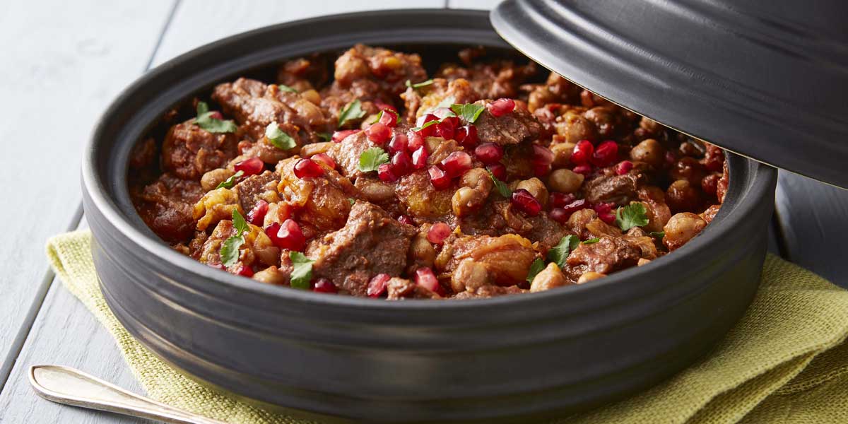 Lamb served in a grey tagine with cous cous and pomegrante pearls