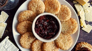 The Boho Baker's Lancashire Cheese Biscuits served on a white plate around a pot of onion marmalade