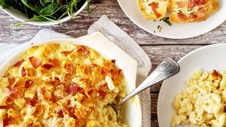 Lancashire Macaroni Cheese served in a white dish with a portion removed