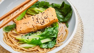 Lapsang Souchong Poached Salmon served in a white bowl with chopsticks and toppped with sesame and nigella seeds