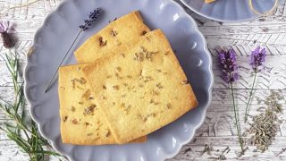 White Chocolate and Lavender Shortbread served on a purple plate surrounded by sprigs of lavender