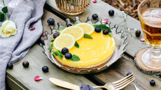 Lemon Jelly Cheesecake served in a crown shaped dish with slices of lemon and fresh blueberries