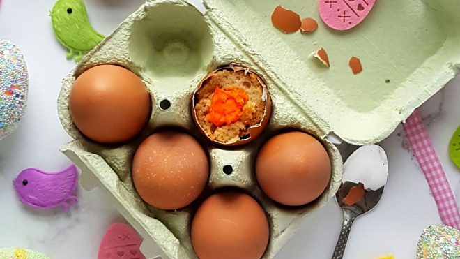 Magic Cake Eggs served in an egg carton with the top of one egg missing to see the filling