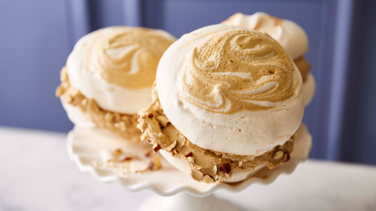 Salted Caramel and Coffee Meringue Sandwiches served on a white cake dish