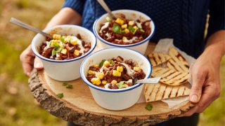 Mexican Mole Chilli served in dishes, on top of a wooden board with grilled tortillas