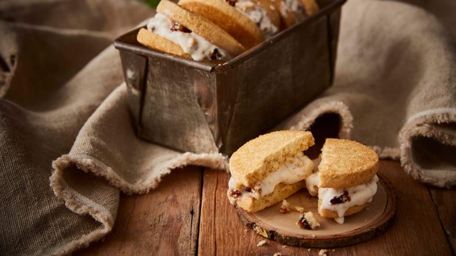 Mince Pie Ice Cream Shortbread Sandwiches served in a baking tin, with one sandwich on a wooden plate