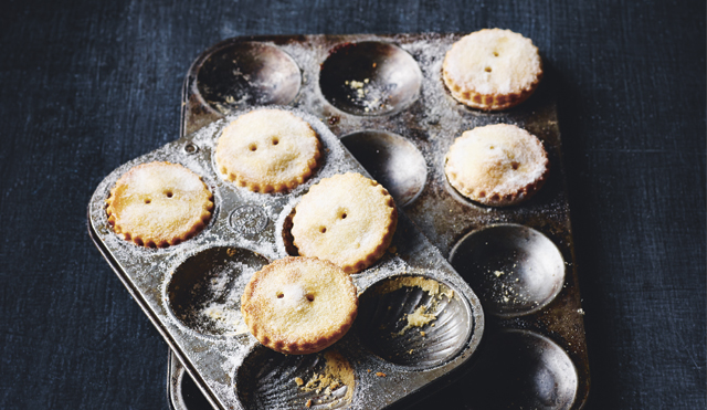 Classic Mince Pies, dusted with icing sugar sitting in their baking trays