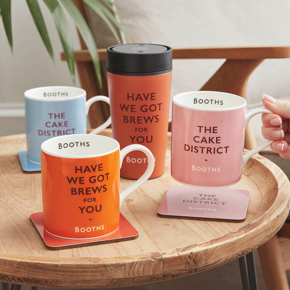 A group shot of Booths pun mugs and coasters