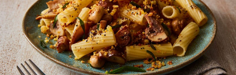 Mushroom and Rosemary Pasta served on a blue plate