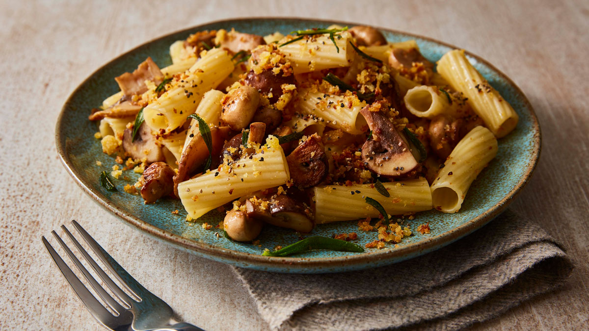 Mushroom and Rosemary Pasta served on a blue plate