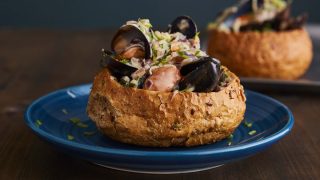 Mussels En Croustade served on a blue plate