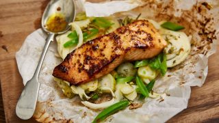 Salmon Fillet with honey and Wholegrain Mustard served in parchment paper on a bed of green vegetables