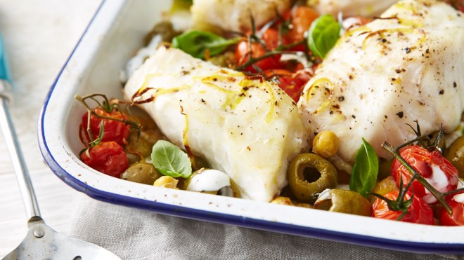 One Pot Cod Supper served in a baking dish with vine tomatoes and olives and capers