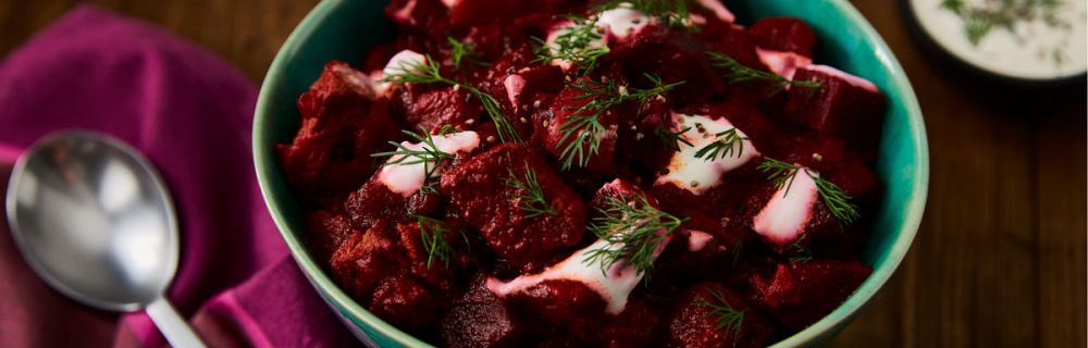 Paprika Beef and Beetroot Goulash topped with dill served in a turquoise bowl
