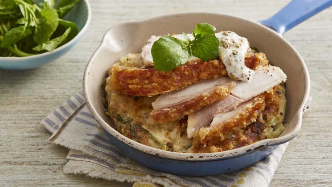 Potato and Apple Cakes with Leftover Roast Pork served in a casserole dish on top of a striped table cloth