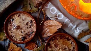 Pumpkin Pue Brulee served in ramekins surrounded by autumnal leaves and twigs